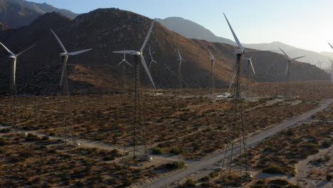 Aerial-view-of-drone-spinning-and-revealing-huge-wind-farm-and-wind-turbines-near-Palm-Springs-in-the-Mojave-Desert,-California,-USA