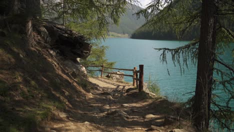 Scenic-hiking-trail-at-shoreline-of-beautiful-alpine-lake