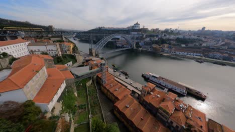 Fly-over-red-rooftops-towards-Aerial-Dom-Luis-bridge-Porto-Portugal-FPV-drone