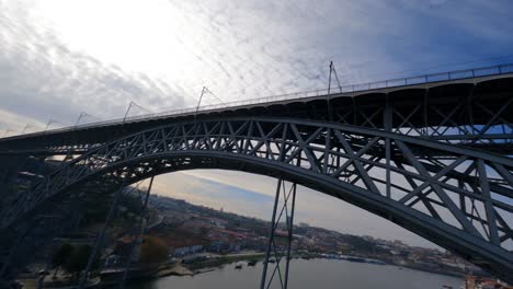 Flying-drone-in-crazy-spins-over-water-FPV-drone-Dom-Luis-bridge-Porto-Portugal