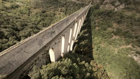 Spectacular-aerial-fpv-drone-shot-of-Ponte-delle-Torri-and-Albornoz-fortress,-Italy