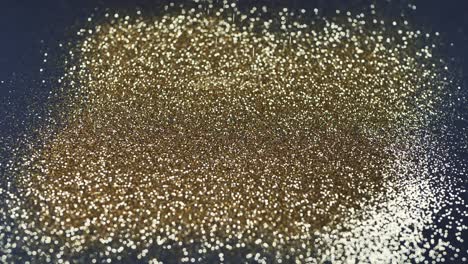 Gold-dust-falls-on-a-black-background