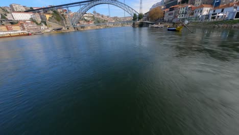 Speeding-by-boats-in-Europe-over-river-FPV-drone-Dom-Luis-bridge-Porto-Portugal