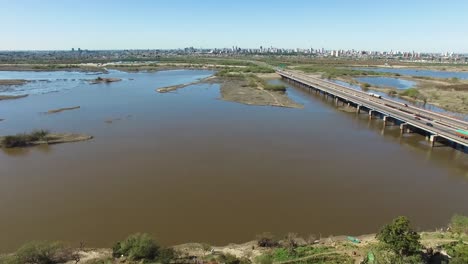 Aerial-View-of-Highway-Bridge-and-Santa-Fe-City,-Argentina-in-Skyline-on-Summer-Day