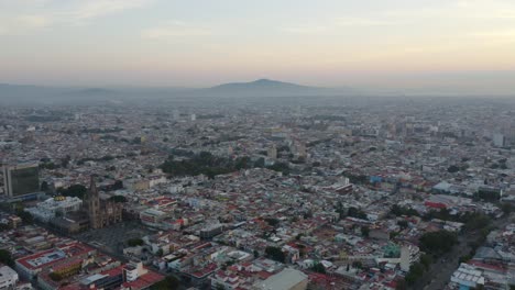 Beautiful-Aerial-Shot-of-Guadalajara,-Mexico-with-Mountain-in-the-Distance