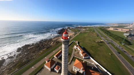 Crazy-FPV-orbit-and-building-dive-around-lighthouse-low-flying-over-rocky-coast