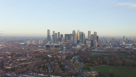 Dolly-forward-drone-shot-of-Canary-Wharf-skyscrapers-from-the-South-at-sunrise