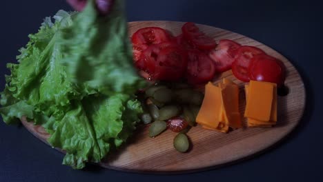 Slowly-preparing-salad-dish-on-wooden-board