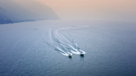 Cinematic-Aerial-Drone-View-of-two-Speed-Boats-Racing-on-Iseo-Lake,-Italy