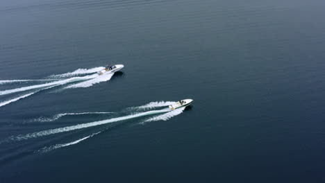 Flying-Away-Shot-of-Speed-Boats-Sailing-On-Lake-Along-Each-Other