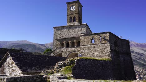 Beautiful-clock-tower-of-citadel-with-stone-high-walls-in-Gjirokaster,-Albania