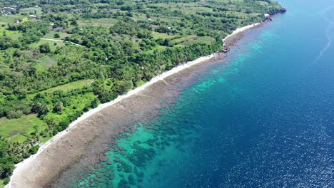 Aerial-view-of-a-beach-with-turquoise-sea-in-Negros-Oriental,-Philippines,-paradise-for-holidays-during-a-sunny-day