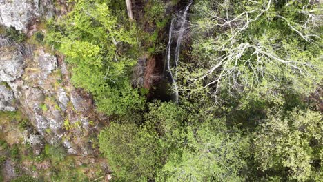 Waterfall-of-Barbelote-in-Monchique,-Faro-district,-Algarve,-Portugal---Tilt-Up-Reveal-Aerial-shot