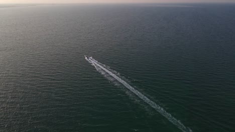 Aerial-shot-of-a-long-tailed-speedboat-going-towards-the-Arabian-sea