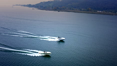 Cinematic-Aerial-Drone-View-of-two-Speed-Boats-Racing-on-Iseo-Lake,-Italy