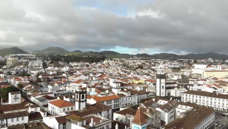 Ponta-Delgada-cityscape-in-an-overcast-day-in-São-Miguel-Island,-Azores,-Portugal---High-angle-Orbit-Aerial