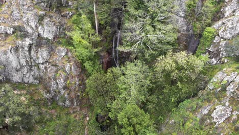 Barbelote-Waterfall-in-Serra-de-Monchique-in-Faro,-Algarve,-Portugal---High-angle-Orbit-Aerial-shot