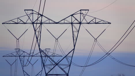 Close-up-of-electrical-towers-against-an-overcast-sky