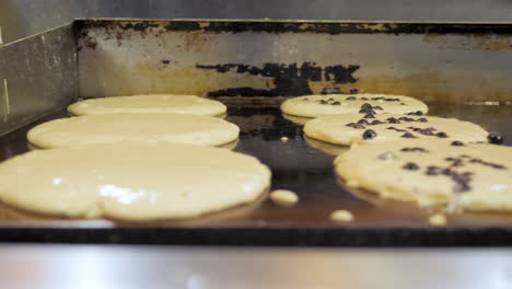 Buttermilk-and-chocolate-chip-pancakes-sizzle-on-flattop-grill,-slider----4K