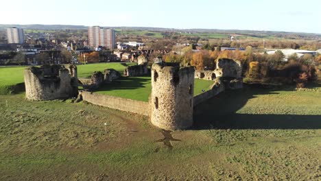 Historical-Flint-castle-medieval-military-ruins-landmark-aerial-view-pull-away-rising-reveal