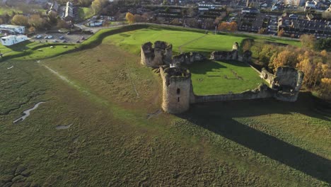 Historical-Flint-castle-medieval-military-ruins-landmark-aerial-view-slow-descend-to-closeup