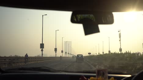 dash-cam-video-on-bridge-moring-goldern-light-car-pov-front-dashboard-and-back-mirror-on-highway-Mumbai-India-Maharashtra-thane-Navi-Mumbai-aroli