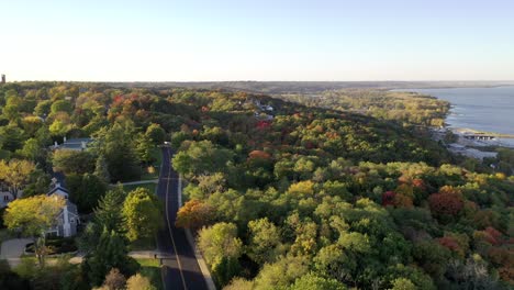 Beautiful-reveal-drone-shot-of-Grandview-Drive-in-Peoria-Illinois-during-the-start-of-the-autumn-season