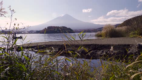 Man-on-boat-catching-fish-close-to-shore-of-Lake-Kawaguchiko-and-Mt