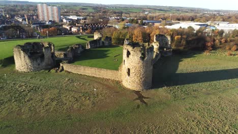 Historical-Flint-castle-medieval-military-ruins-landmark-aerial-view-rising-horizon-shot