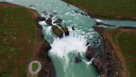 Tilt-up-pullback-shot-of-Godafoss-waterfall-cascades---North-Iceland---Diamond-Cirlcle---Aerial-4k