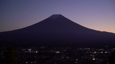 Beautiful-wide-symmetrical-view-of-Mount-Fuji-Silhouette-at-dusk-with-city-in-view