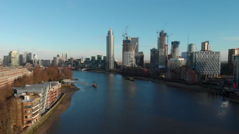 Falling-drone-shot-over-Thames-river-towards-The-Tower-Vauxhall-London