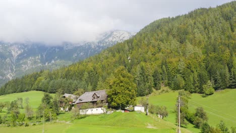 Chalet-on-clearing-of-picturesque-Mount-Peca-and-Topla-Valley,-Alps