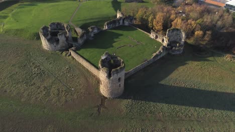Historical-Flint-castle-medieval-military-ruins-landmark-aerial-view-birdseye-pull-away-left-tilt-up