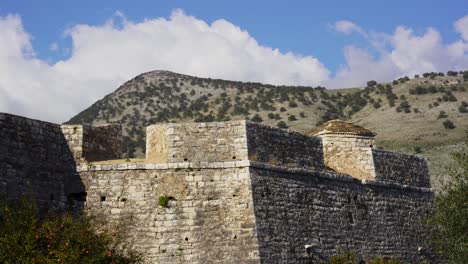 Medieval-castle-stone-walls-of-fortress-with-mountain-background-in-Mediterranean