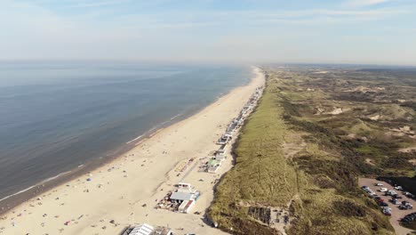 Long-and-wide-Wijk-aan-Zee-beach,-soft-sand,-smooth-water-and-dunes,-Holland