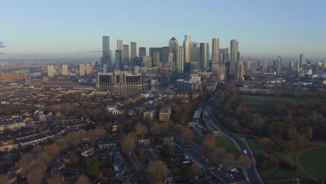 Slow-Dolly-back-drone-shot-of-Canary-Wharf-skyscrapers-at-sunrise