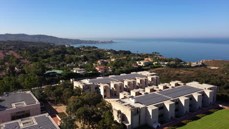 Drone-Ascending-Next-To-Salk-Institute-In-La-Jolla-California-With-Trees-And-Ocean-In-The-Background---Aerial