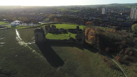 Ancient-Flint-castle-medieval-heritage-military-Welsh-ruins-aerial-view-landmark-slow-descend-push-in