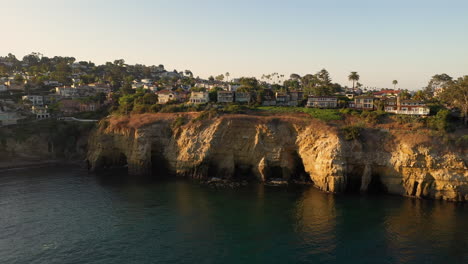 Scenic-View-Of-La-Jolla-Sea-Caves-In-San-Diego,-California-On-A-Sunset---wide-drone-shot