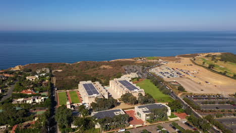 The-Salk-Institute-On-Coastal-Cliff-In-La-Jolla-With-Torrey-Pines-Gliderport-In-The-Background---aerial-drone