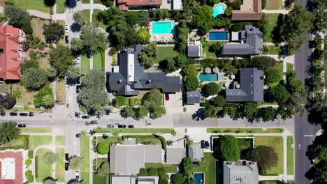 Drone-flying-over-palm-tree,-mansion-and-pool-dotted-neighborhood-in-beautiful-West-Hollywood,-Los-Angeles,-California