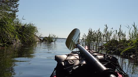 first-person-view,-canoe-in-river-approaching-large-body-of-water