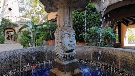 A-fountain-made-of-decorative-tile-and-a-carved-stone-center-post-in-a-traditional-Mexican-motif,-Tlaquepaque-Arts-and-Shopping-Village,-Sedona,-Arizona