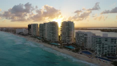 Drone-Flies-Over-Hotels-during-Gorgeous-Sunset-in-Cancun,-Mexico