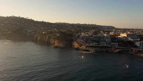 Snorkelers-And-Scuba-Divers-In-The-Water-With-View-Of-La-Jolla-Sea-Caves-After-Sunrise-In-California---aerial