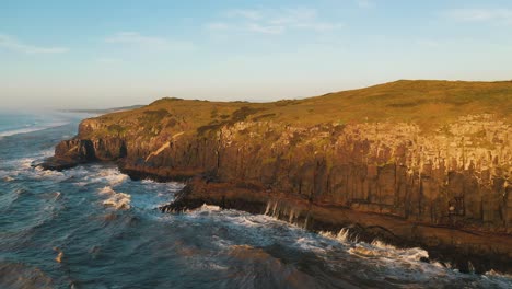 Rocky-cliffs-on-atlantic-ocean-at-sunrise-drone-point-of-view