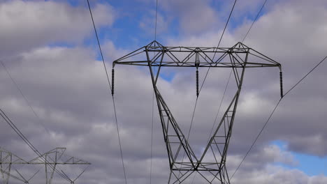 Top-part-of-electrical-pylon-with-insulators-and-transmission-lines