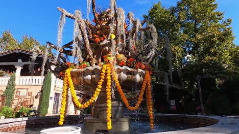 The-main-fountain-at-the-shopping-and-Arts-village-Tlaquepaque,-Sedona,-Arizona,-is-decorated-with-skeletons-of-cactus,-moss,-gourds,-vines,-and-pumpkins-for-fall