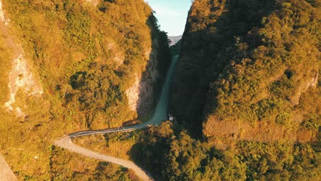 Amazing-road-inside-a-tropical-rainforest-mountain-crack-at-sunrise-aerial-view,-Serra-Do-Corvo-Branco,-Grão-Pará,-Santa-Catarina,-Brazil